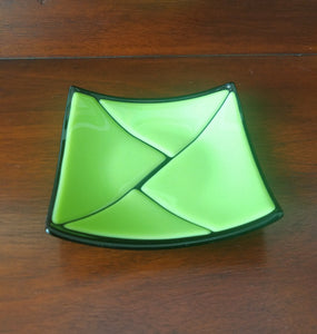 This beautiful hand-crafted green on black decorative glass plate has a design of triangular pieces. Dimensions: 5-3/4" x 5-3/4" x 3/4".
