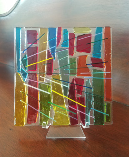 Want sunshine?  This beautiful hand-crafted flat decorative glass plate is a like a prism of colors from sunshine that can almost be heard as well as seen. Dimensions: 5-3/4