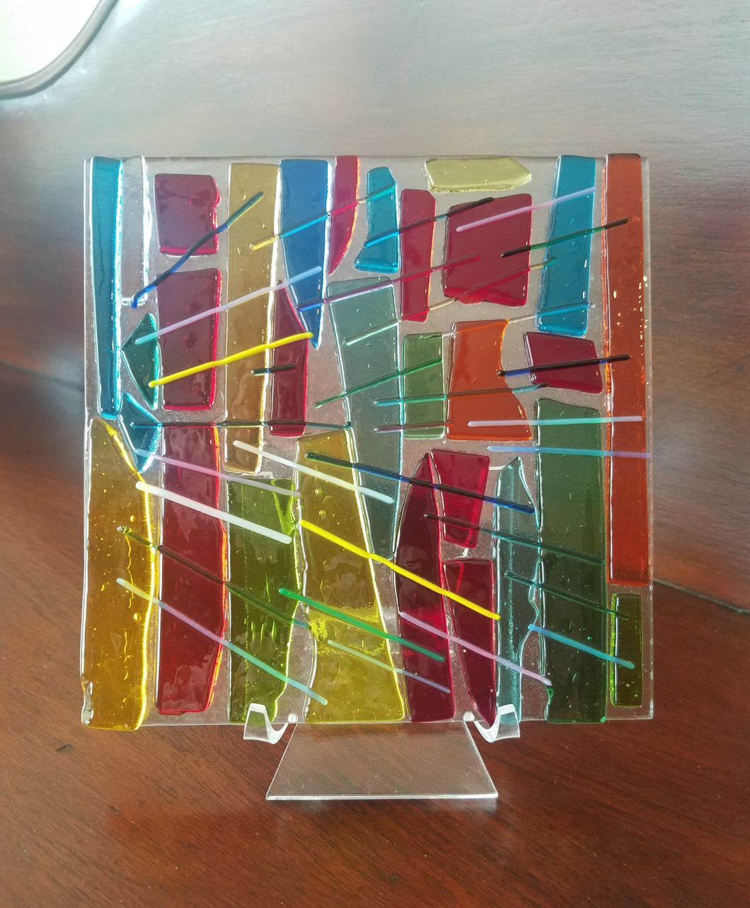 Want sunshine?  This beautiful hand-crafted flat decorative glass plate is a like a prism of colors from sunshine that can almost be heard as well as seen. Dimensions: 5-3/4