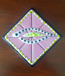 Hand-crafted decorative glass plate, a pretty pink background with an interesting eye design.  Dimensions: 5-3/4" x 5-3/4" x 1/2"