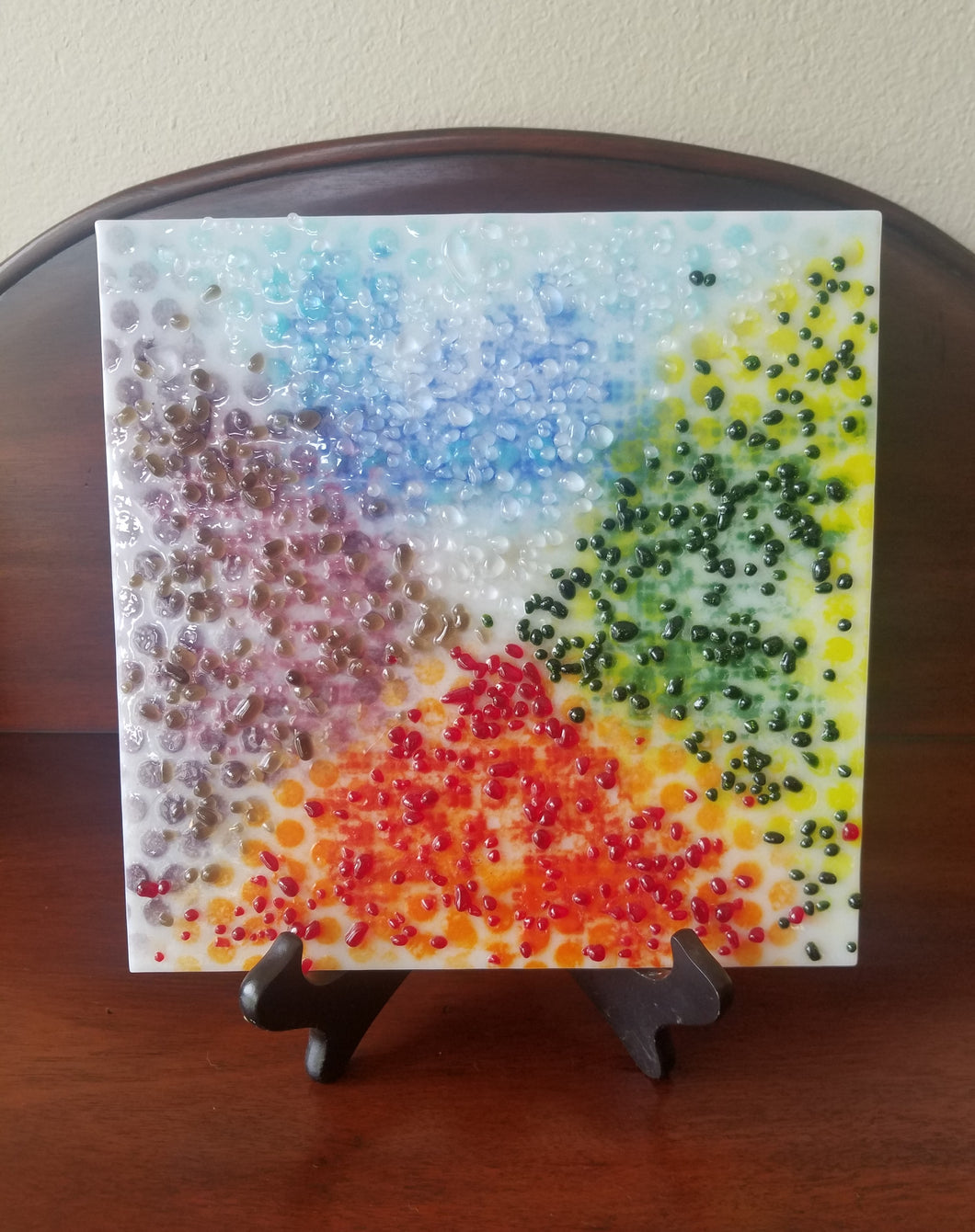 Beautiful hand-crafted decorative glass plate with an abstract design of wind, earth, wind, and fire.  Dimensions: 9
