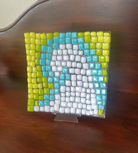 Mosaic wave of yellow, blue and white, curved decorative glass plate. 