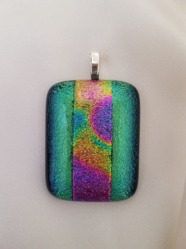 These beautiful, hand-crafted glass rectangular pendants, approximately 1-3/4 inches by 1-1/8 inches, are sold individually, each with a unique design.  Great gift!  Once sold, that individual pendant is no longer available.  Jewelry.  Artist: KB.  This pendant is Gold-Green with a Black Edge.