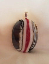 Load image into Gallery viewer, Oval pendant is approximately 1-7/8 inches long, with stripes of grey, brown, red, white and caramel.
